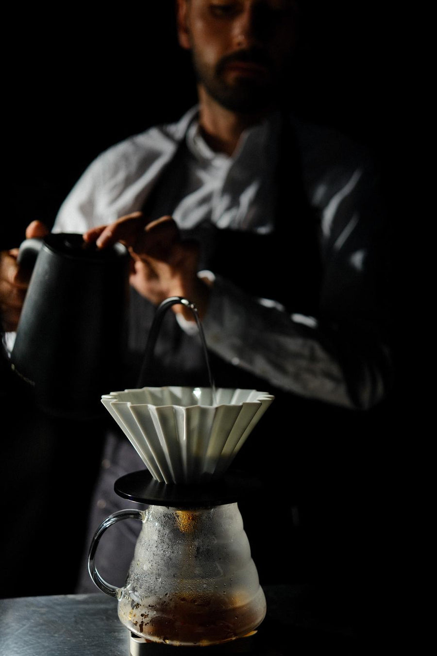 barista doing pour-over coffee with a V60 dripper.