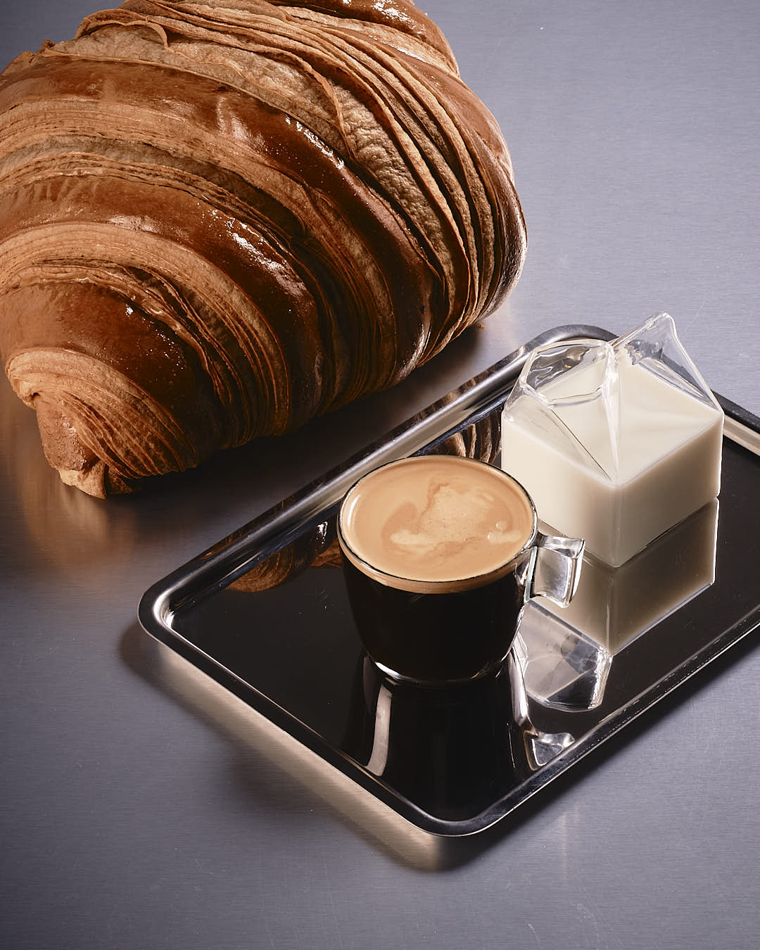 espresso with croissant and milk on tray specialty coffee