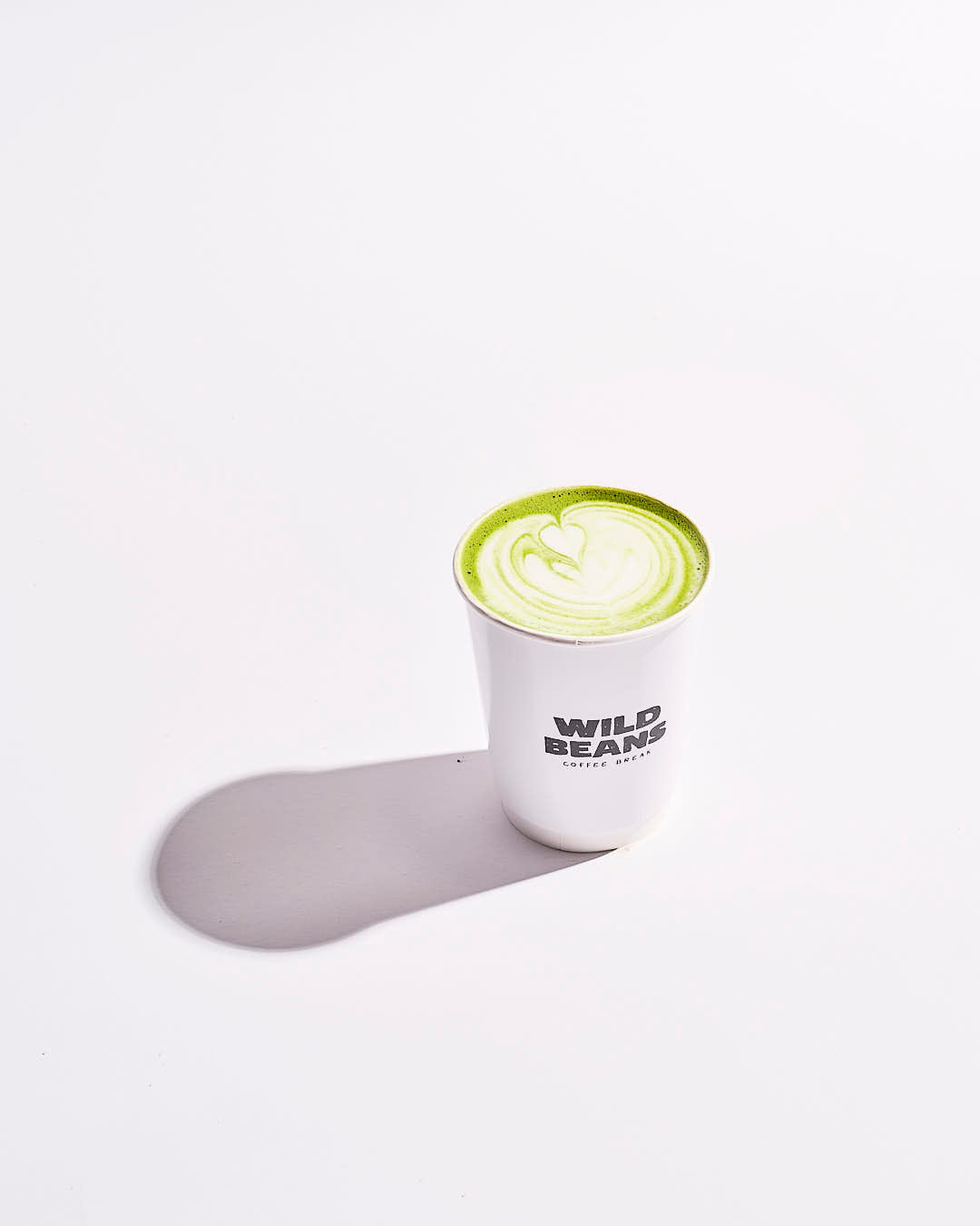 wild beans cup with a matcha dirnk and latte art