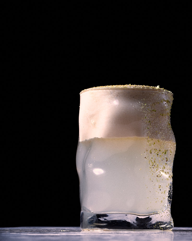 milky coffee drink with creamy foam in glass